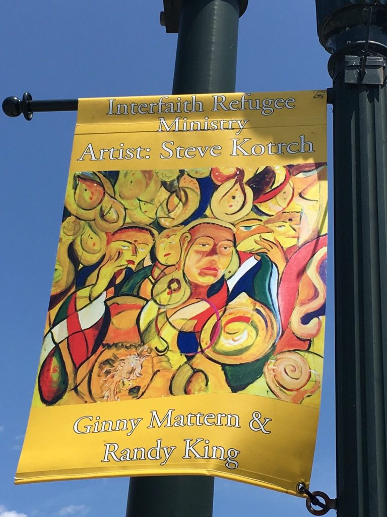 Banner representing the local Interfaith Refugee Ministry chose my painting "Overwhelmed" to represent them on Broad Street