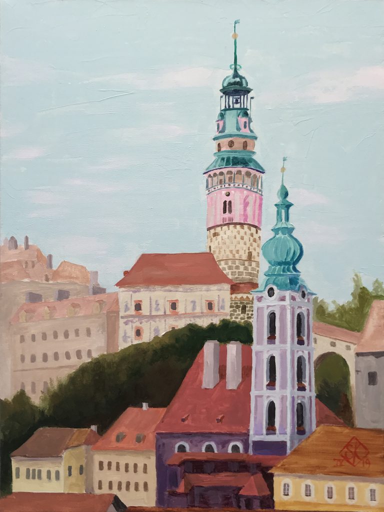 A view of a church tower and the central tower of the castle in Czesky Krumlov, in Czechia