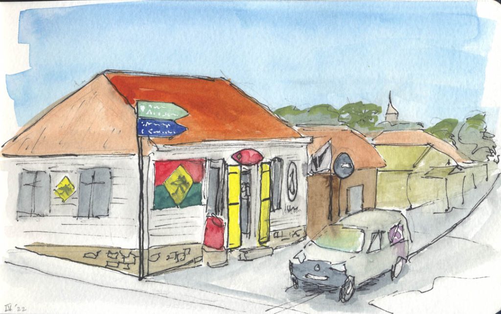 Pen and ink of a colorful scuba shop on a side street in Gustavia, St Barthelemy